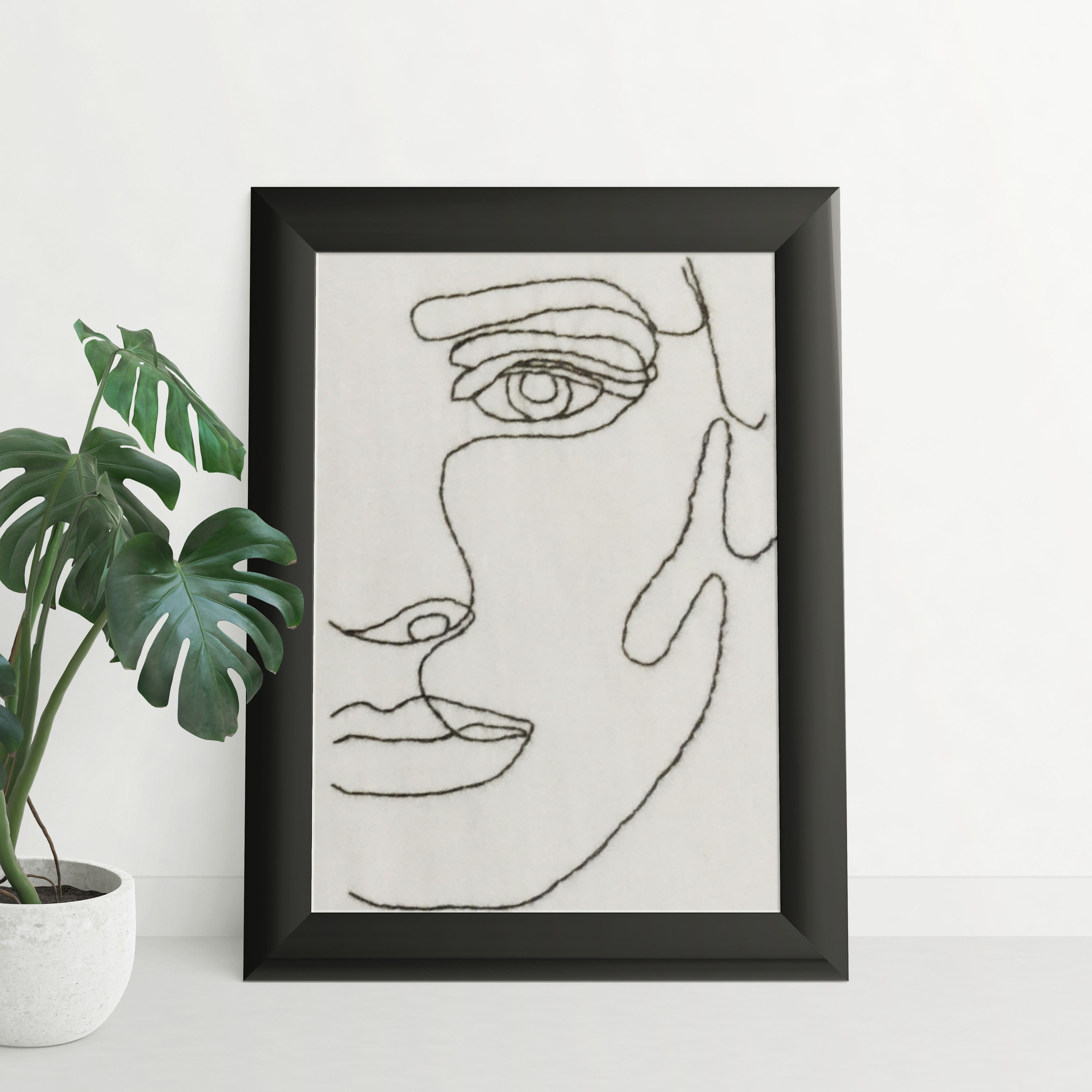 Portrait minimaliste brodé au fil noir